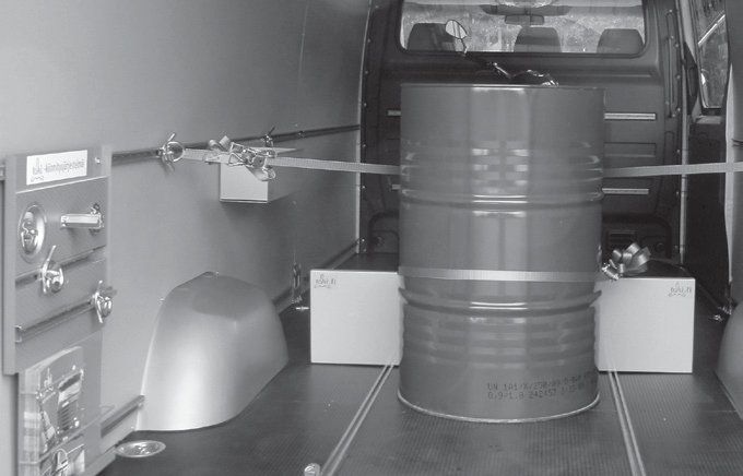 TAKI® partition dividing a van's cargo space, with a barrel behind it